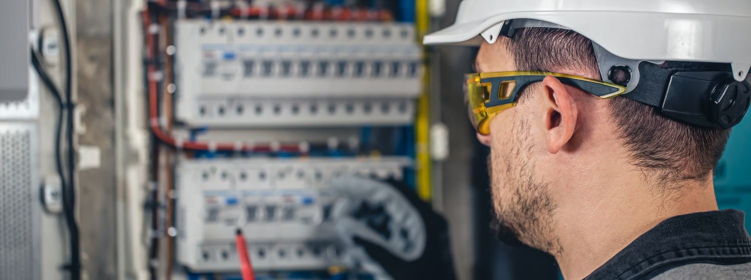Electrician testing a distribution panel