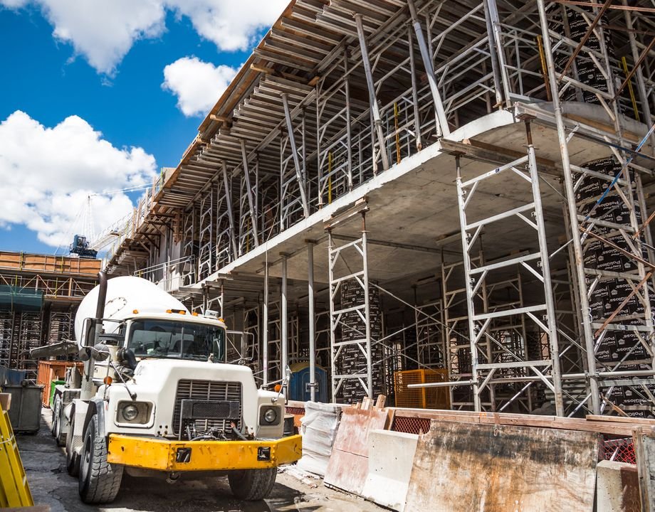 Concrete delivery truck at a scaffolded job site