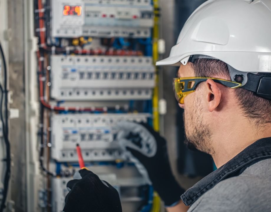 Electrician testing a distribution panel
