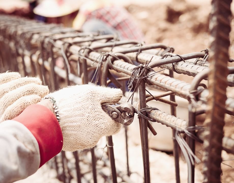 Worker tying rebar reinforcement